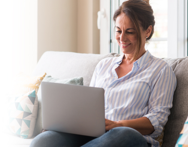 A woman browsing the AmgenNow site to learn about direct-to-patient prescription savings